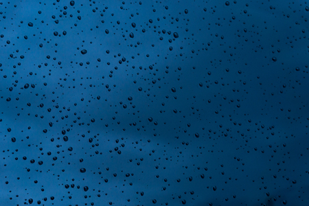 Water drops on dark blue surface  texture backgroundの写真素材