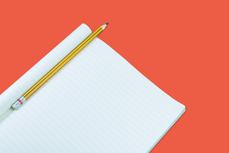 Notebook with pencil isolate on orange background,for art education backgroundの写真素材