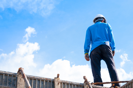 Construction building workers at construction,Man Working at height with blue sky at construction siteの写真素材