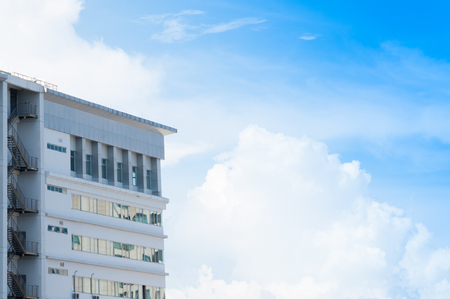 New building architecture with fire escape stairs on blue sky background,Low angle architectural exterior view of modernの写真素材