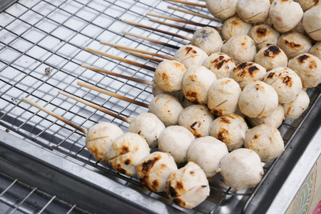 Street food meat ball sticks on grill at Thailandの写真素材