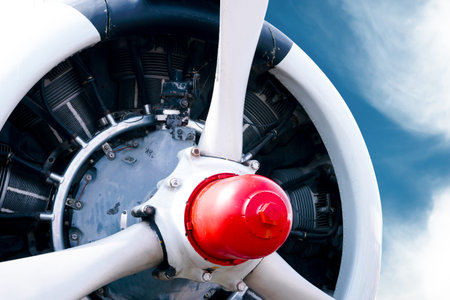 Vintage airplane propeller with radial engine on a beautiful blue skyの写真素材