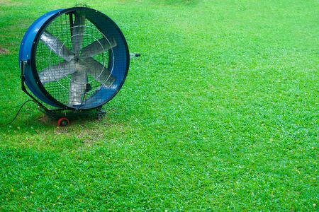 Large round powerful industrial professional metal iron fan with louvres at gardenの写真素材