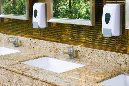 Toilet sink interior of public toilet with of washing hands and mirror golden,clean toilet