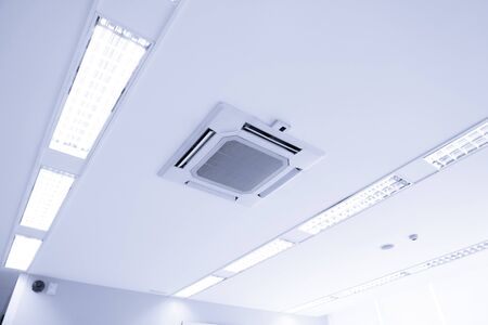 White ceiling mounted cassette type air conditioner for large rooms, exhibition room, for business useの写真素材