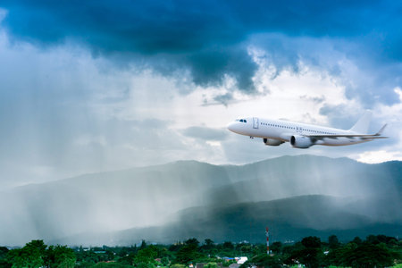 Airplane in the sky with rain over mountain, The plane flies in terrible thunderstorm,Concept of...