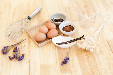 Top View Baking Preparation on wooden Table,Baking ingredients. Bowl, eggs and flour, rolling pin and eggshells on wooden board,Baking conceptの写真素材
