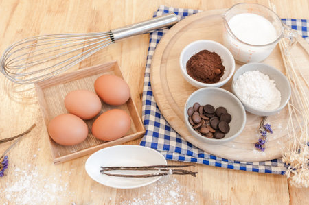 Top View Baking Preparation on wooden Table,Baking ingredients. Bowl, eggs and flour, rolling pin and eggshells on wooden board,Baking conceptの写真素材