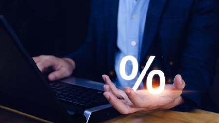 Businessman holding with percentage sign, monetary growth, interest rate increase, inflation concept, Interest rate financial and mortgage rates concept.の写真素材