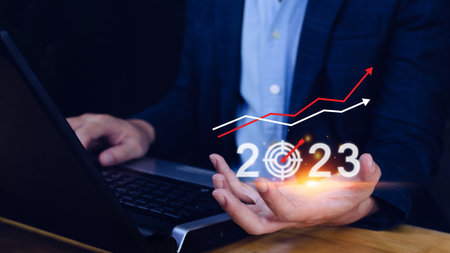 Business target and goal 2023 icon, hand pointing holding 2023 virtual screen and up arrow, Start new year 2023 with a goal plan, action plan, strategy, new year business vision.の写真素材
