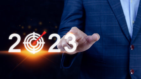 Business target and goal 2023 icon, hand pointing holding 2023 virtual screen, Start new year 2023 with a goal plan, action plan, strategy, new year business vision.の写真素材