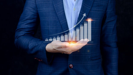 Businessman showing business growth on graph Hands touching graphs representing increasing profits, financial symbols comingの写真素材
