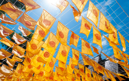 Thammachak flag yellow in temple (Wat Phan tao) on blue sky temple Northern Thailandの写真素材