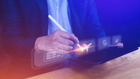 Businessman pointing finger touching to select flight by pressing touch screen airplane button,Business Airplane transportation conceptの写真素材