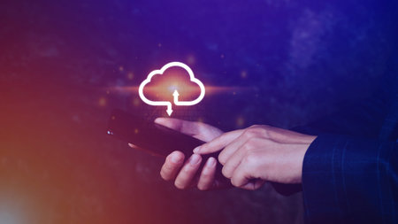 Businessman holding smartphone with virtual cloud computing to transfer database information upload,...