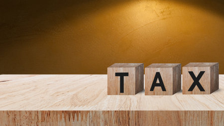 Wooden blocks with the words Tax, Taxes payment concept. Tax evasion. Taxation. Business and finance, Property,tax time.investment planning.business real estate.の写真素材