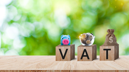 Wooden blocks with words text VAT with US dollar money bag, Taxes payment concept. Tax evasion. Taxation. Business and finance, Property,tax time.investment planning.business real estate.の写真素材