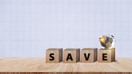 Wooden blocks with words save money Coins for investment loan planned future concept. saving, charity, family finance plan concept, fundraising, superannuation, financial crisis conceptの写真素材