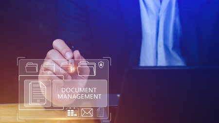 Document Management System (DMS) being setup IT consultant working on laptop computer in office, Software for archiving, searching and managing corporate files informationの写真素材