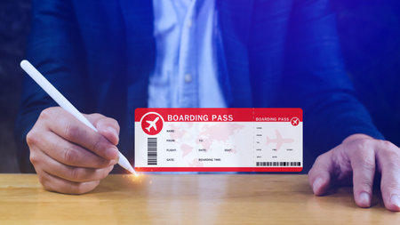 Hand holding boarding pass tickets air travel concept, Choosing checking electronic flight ticket.の写真素材