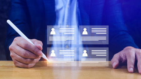 Human resources manager choosing professional profile to hire on virtual screen interface, recruitment concept. Businessman hand pointing icon resource (HR) management conceptの写真素材