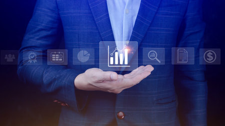 Big data analytics and business intelligence BI concept with chart and graph icons on digital screen interface and business people in the background.の写真素材