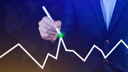 Businessman drawing growth curve, growth forecast chart, bussiness success concept. Hand drawing a graph representing increasing profits.の写真素材