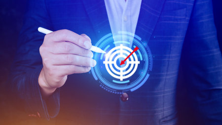 Businessman touching virtual dartboard with red arrow ,Business Achievement objective target concept, setup business objective target concept.の写真素材