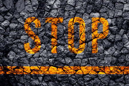 Stop text written with broken cement wall, Stop word on street.の写真素材