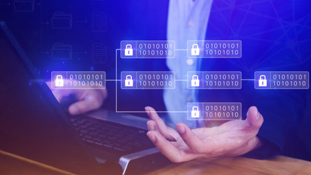 Businessman using a laptop computer to Blockchain technology concept with chain of encrypted blocks...