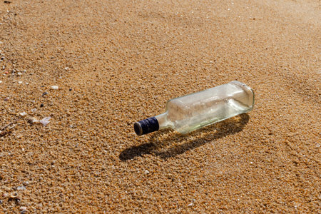 Glass bottles are left on the beach as waste polluting nature, Plastic is hard to degrade, destroy the ecosystem, World environment day concept.の写真素材