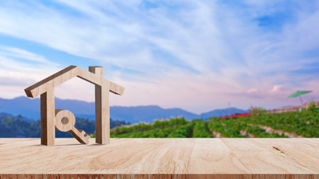 Mockup wooden house and key on wooden table, concept of real estate investment. Planning savings money of coins buy home concept for property, mortgage and real estate investment.の写真素材