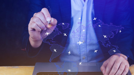 Businessman hand pushing flight booking networking, Hand pressing light blue world map with flight routes airplane, Transportation concept.の写真素材