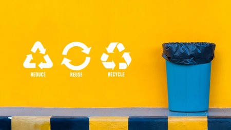 Reduce, reuse, recycle symbol with garbage bin on yellow background, Ecological concept, ecological metaphor for ecological waste management and sustainable and economical lifestyle.の写真素材