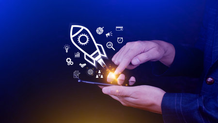 Startup business concept, rocket launching and flying from hand to sky for growing business, fast...