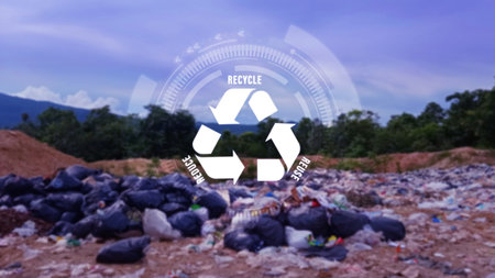 Reduce, reuse, recycle symbol on big garbage pile industry background, ecological metaphor for ecological waste management and sustainable and economical lifestyle.の写真素材