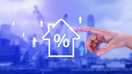 Real estate property investment concept, Asset management, Interest rates, inflation, loan mortgage, increase tax. Hand holding house icon with percent and rise arrow.の写真素材