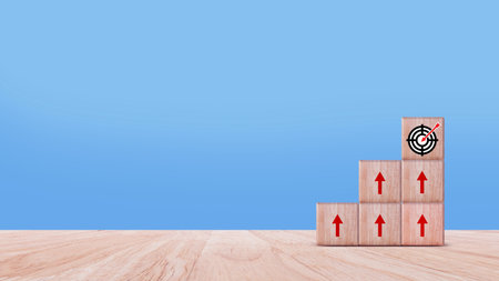 Target concept, objective, virtual target board and rising arrows screen printed on wooden cubes. set goals for business success.の写真素材