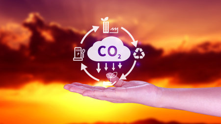 Hand holding CO2 reducing virtual icon for decrease carbon dioxide emission, carbon footprint and carbon credit to limit global warming from Bio climate change concept.の写真素材