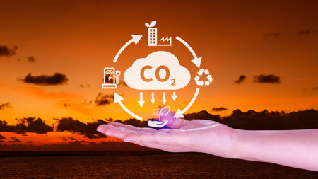 Hand holding CO2 reducing virtual icon for decrease carbon dioxide emission, carbon footprint and...