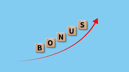 Bonus concept on wooden cube, suggests additional reward or incentive provided to individuals based their performance achievement, saving and manage money to success businessの写真素材