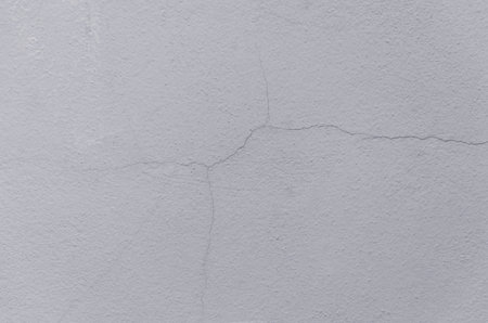 Cracked wall texture cement concrete floor background, Plaster facade house wall with grey dark...