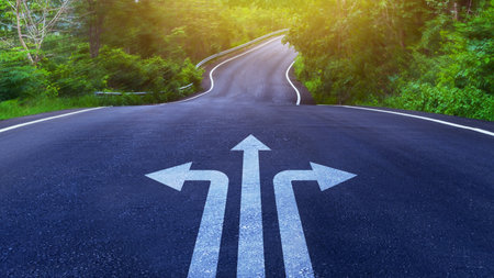 Arrows on asphalt road ground with three direction arrow choices, left, right or move forward on Curve of the road, difficult decision making concept, Motivation and growth.の写真素材