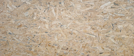 OSB boards made of brown wood chips sanded into wooden background. Wood plank texture background,...