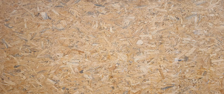 OSB boards made of brown wood chips sanded into wooden background. Wood plank texture background,...