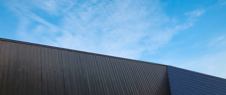 Metal sheet roof curve on blue sky. Modern construction, Metal ribbed arch span roof covering, Large...