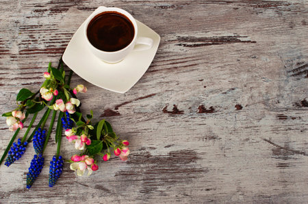 Cup of delicious coffee and beautiful flowers.