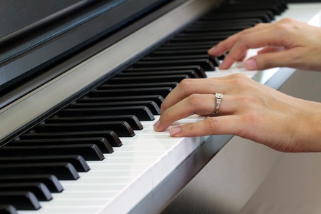 Female hands playing pianoの写真素材