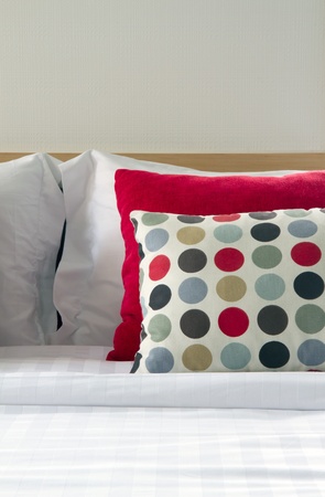 Close up a pillow on a bed in a bedroomの写真素材