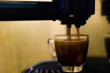 coffee machine preparing cup of coffee (espresso)の写真素材